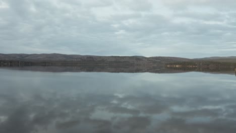 Aerial-shot-reveals-lake-and-park-bench