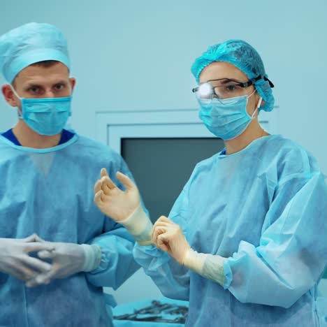 surgeons wear sterile clothing before surgery. a team of surgeons preparing for surgery.