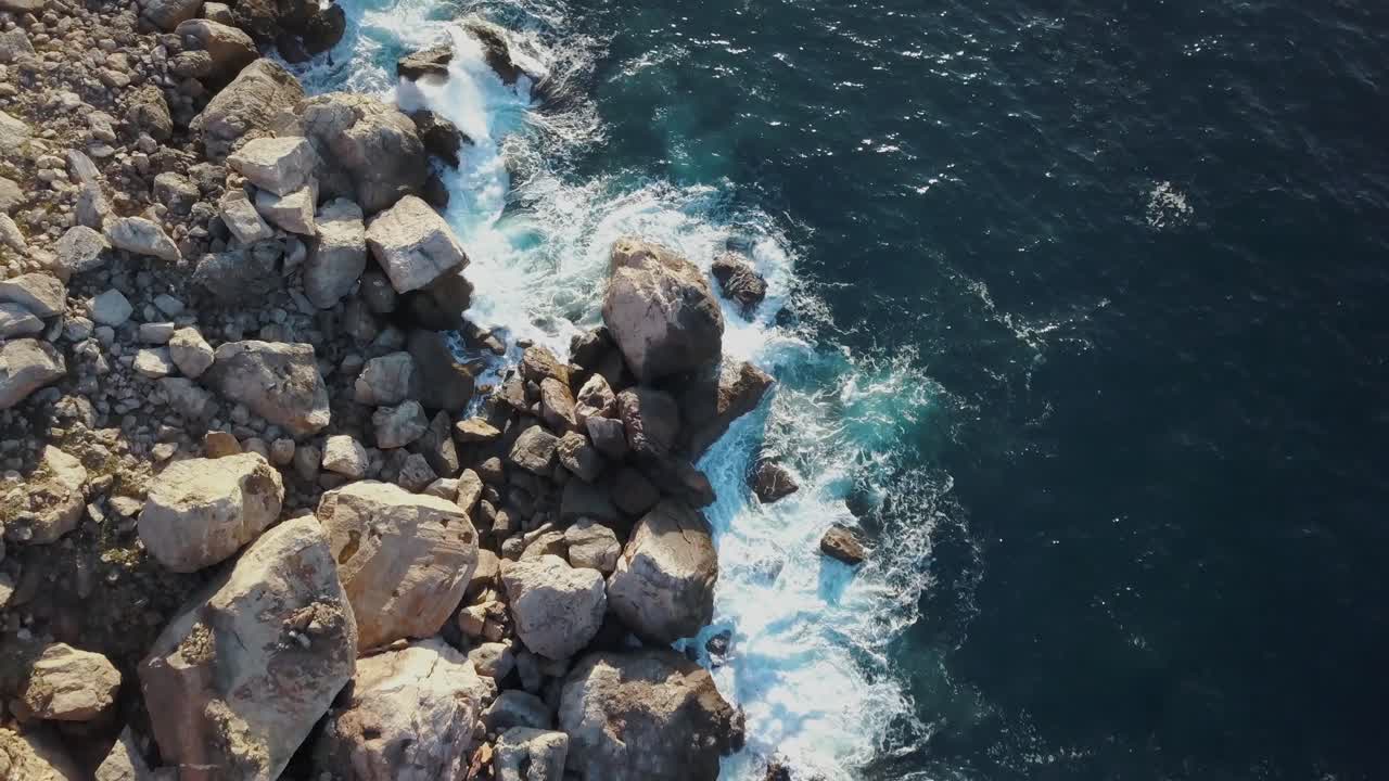 Aerial footage of rocks in the ocean - Small waves - Mediterranean Sea Mallorca