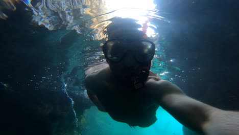 selfie view an adult is swimming underwater in