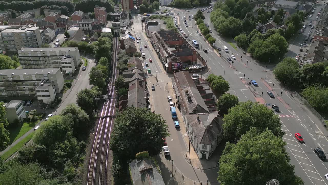 Cars And Train Traveling Through The Street In St. Mary's City, Southampton, England. - aerial shot