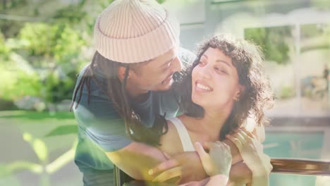 animation of grass over biracial man and disabled woman sitting in wheelchair