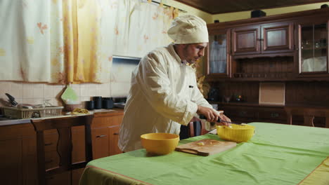 home chef cuts potatoes to make them fried on the table