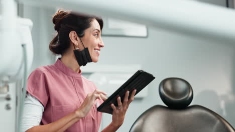 female dentist using a tablet in her office