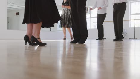 mixed-race-male-dance-teacher-taking-a-ballroom-dancing-class-at-a-dance-studio