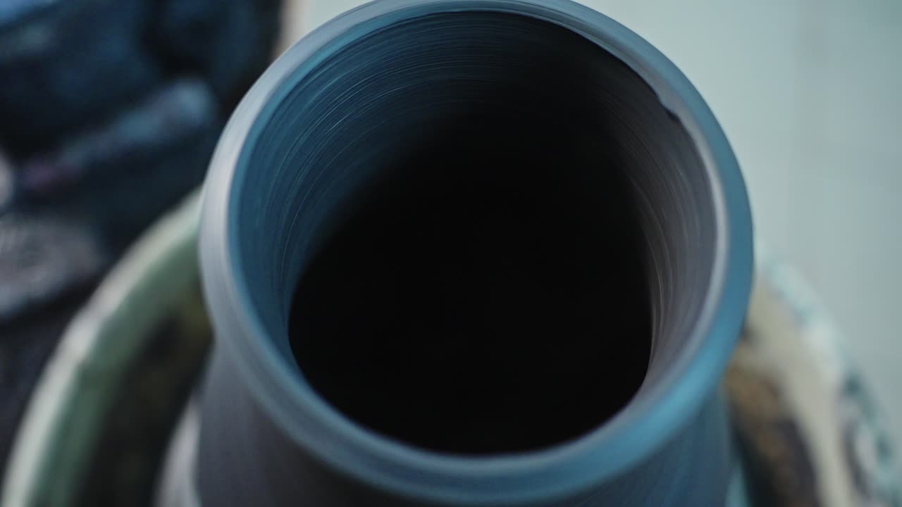Close-up view of pottery being shaped on a potter's wheel
