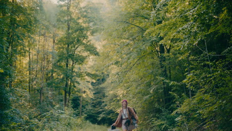 carefree female hiker exploring forest