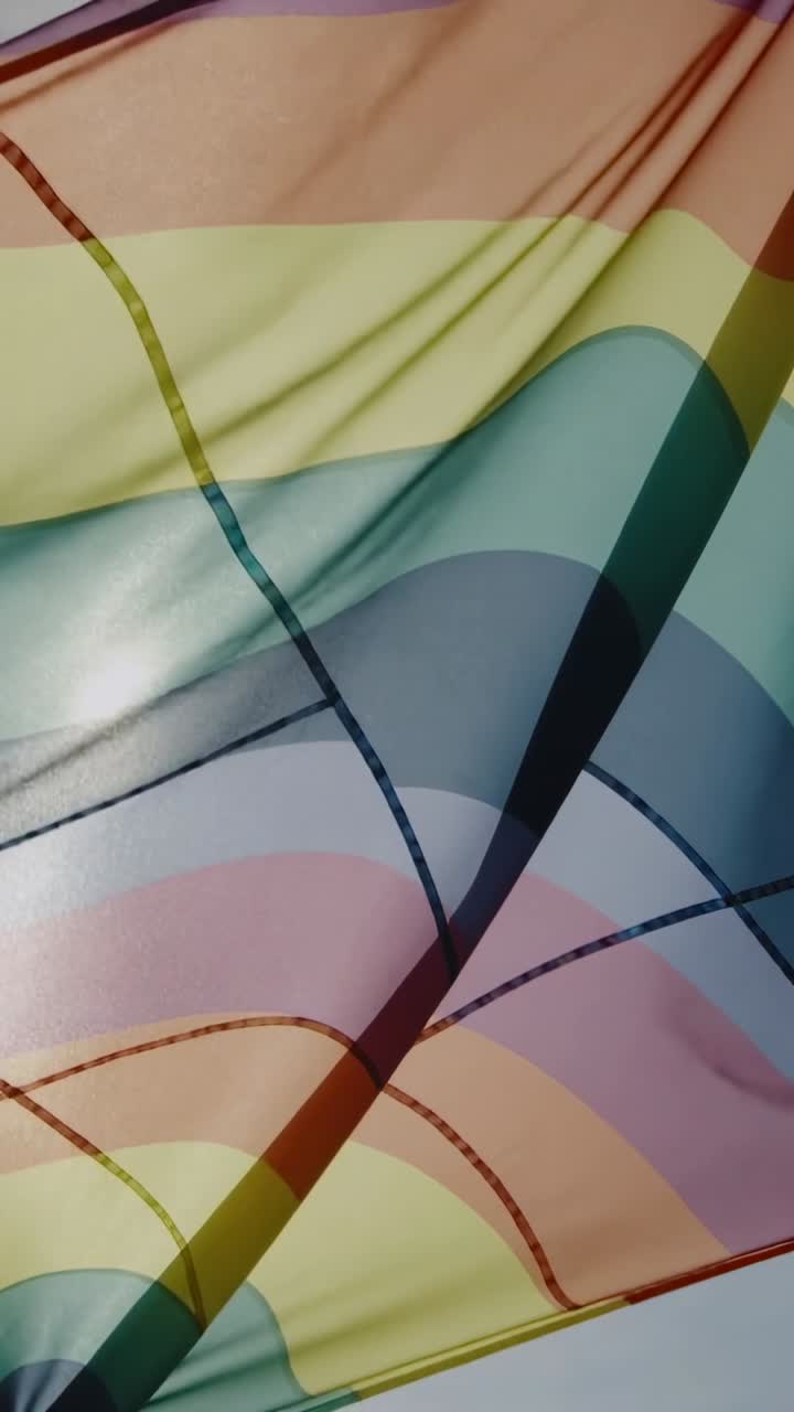 Vertical video: Rippling rainbow flag shifting outside in breeze showing stitched seams and shine