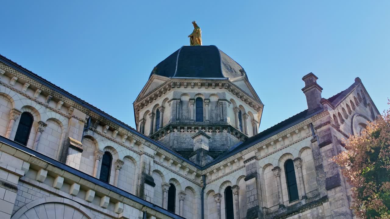 Tilt up across Eglise Notre-Dame with dome, gothic architecture, under blue sky, establish