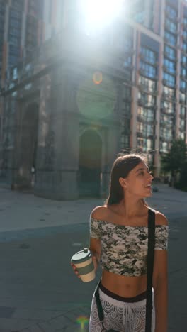 young woman enjoying coffee outdoors in city