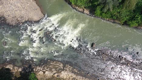 aerial view of a river rapids in a lush forest