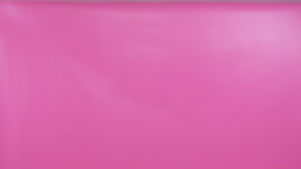 Woman moving across the frame in slow motion with glossy makeup and soft curls