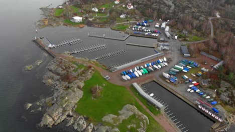 aerial view of small harbor with empty docks and winterized boats ashore