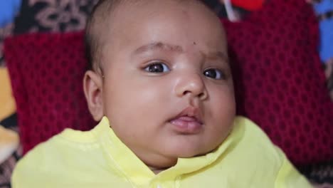 infant-boy-in-traditional-indian-outfit-lying-on-sofa-cute-facial-expression-at-indoor