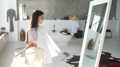 woman trying on clothes in a luxurious bathroom