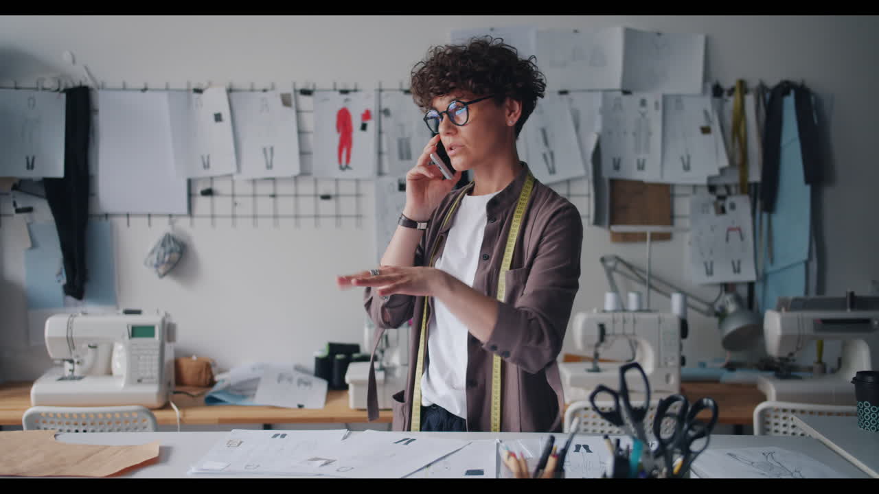 Fashion Designer Talking on Phone in a Design Studio