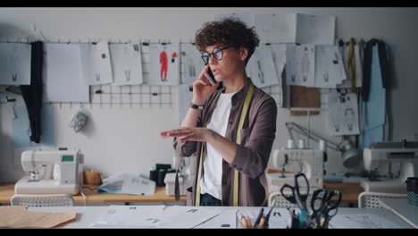 fashion designer talking on phone in a design studio