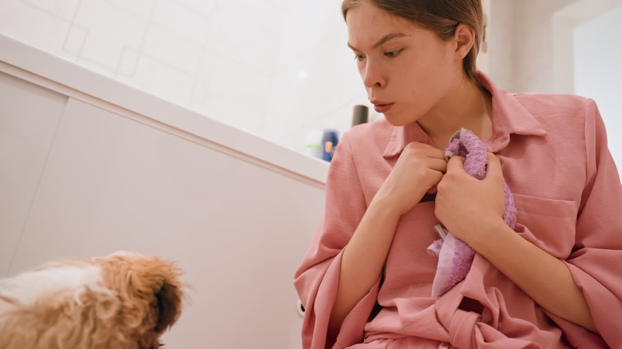 Woman Interacts Tenderly With Her Pet Dog, Woman Shares Gentle Moment With Her Small Dog In Home Setting, An Intimate Scene Showing Woman Nurturing Her Pet Dog With Affection And Calmness