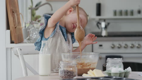 cute little girl baking mixing ingredients in bowl preparing recipe for homemade cupcakes having fun making delicious treats in kitchen 4k