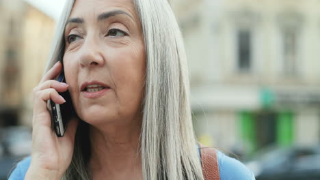 Close-Up-Ofsenior-Woman-Speaking-On-The-Phone-While-Being-Outdoors