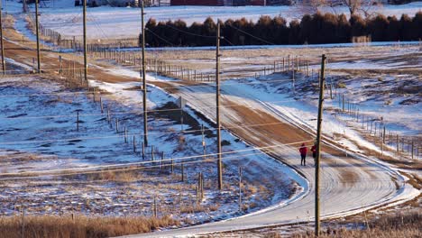 couple running on a dirt road in the countryside
