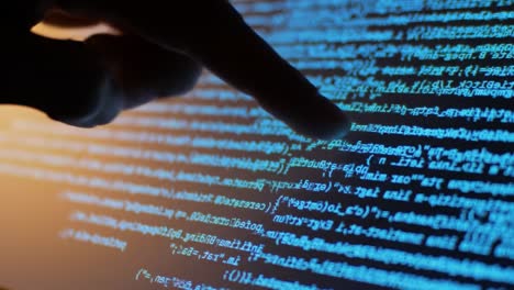 a close-up view of a finger interacting with glowing code on a screen, representing programming, technology, and digital interaction in a modern context