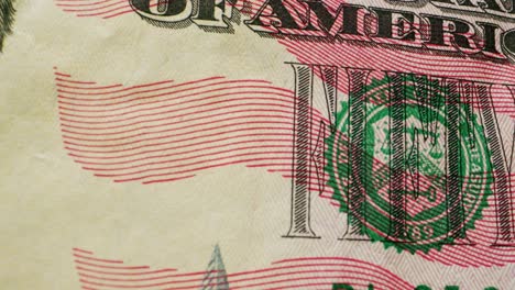 a closeup view of a fifty dollar bill on a polished wooden table, highlighting its intricate design