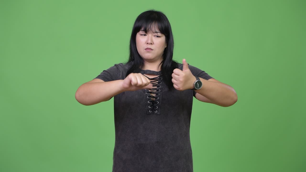 Beautiful overweight Asian woman being indecisive