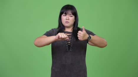 beautiful overweight asian woman being indecisive