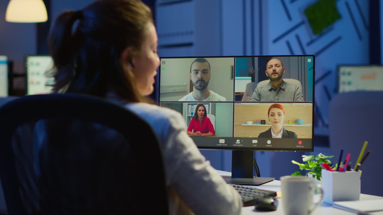 Back view of business woman talking about sale report in video conference