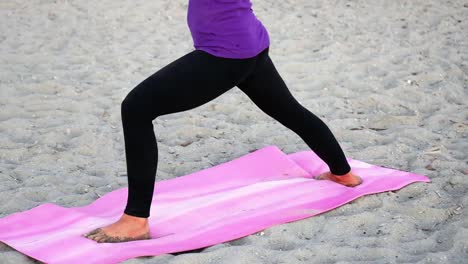 Woman-performing-stretching-exercise-on-the-beach