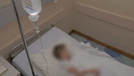 sick child and medical dropper in hospital