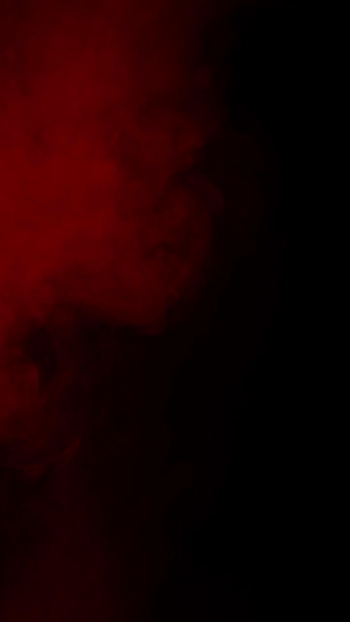 Vertical format deep red fog or smoke rolling slowly on black background for cinematic effect, seamless loop