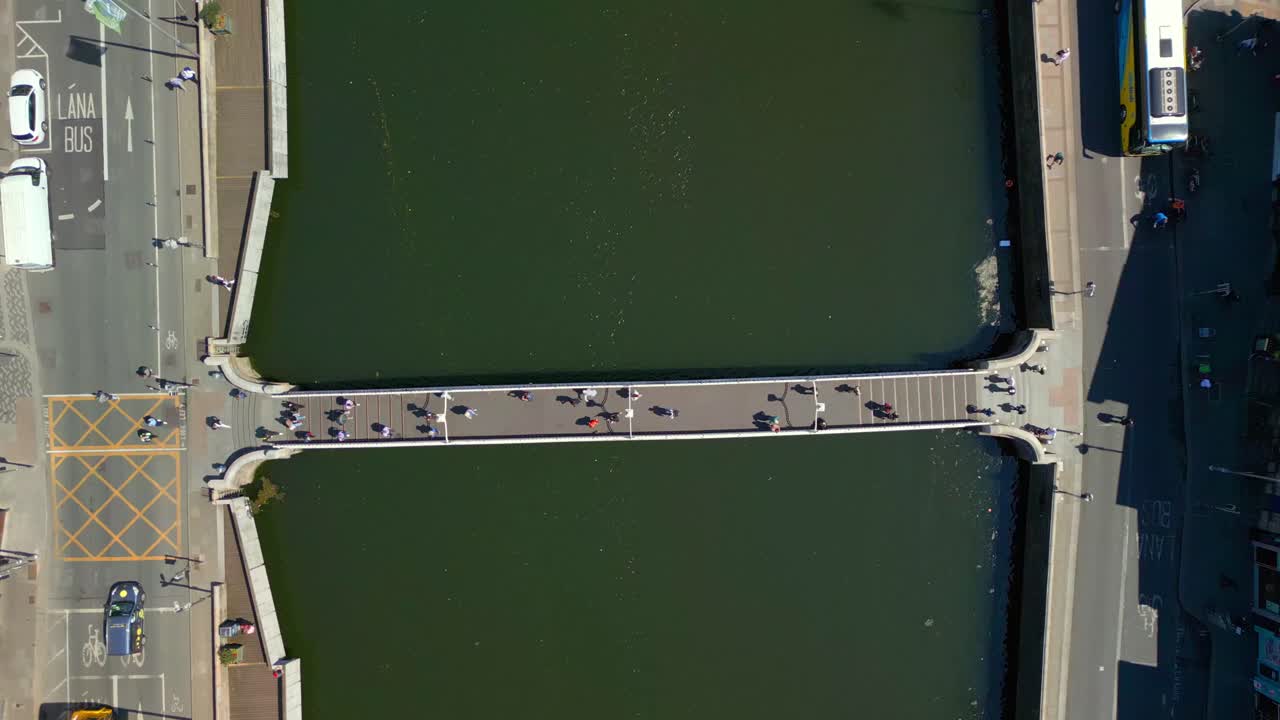 Overhead, downwards aerial video of the River Liffey, various bridges and Dublin City Centre in Dublin, Ireland on a bright and sunny day. Filmed in 4K, 60FPS and with Rec709 color.