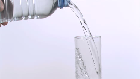 water bottle filling in super slow motion a glass