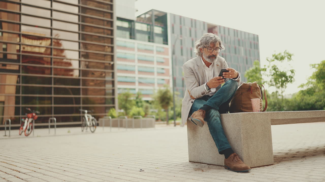 Man using mobile phone in urban setting