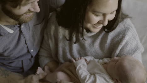 loving parents holding newborn baby