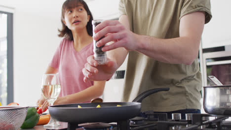 video of happy diverse couple preparing meal together