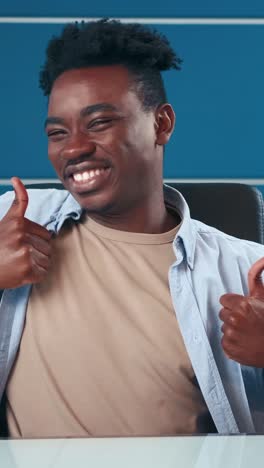 happy young man expressing joy in a modern office setting