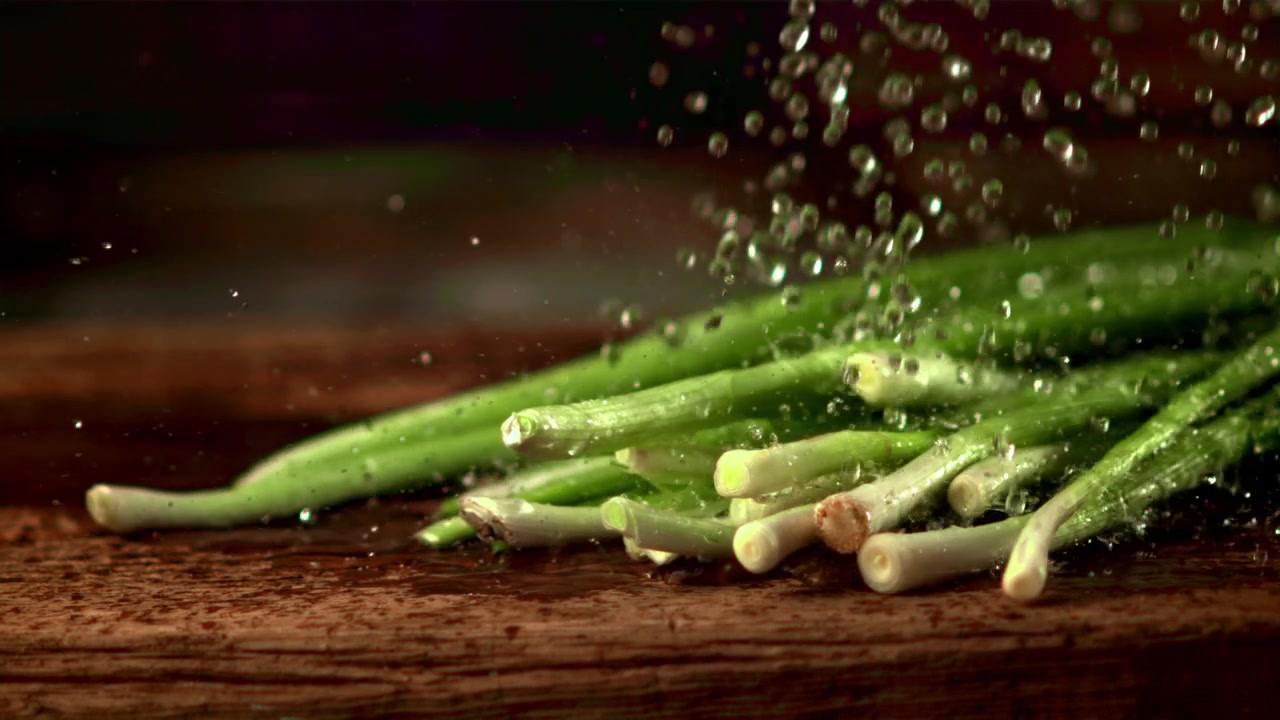 Slow Motion Water Drops Rinsing Fresh Green Onions