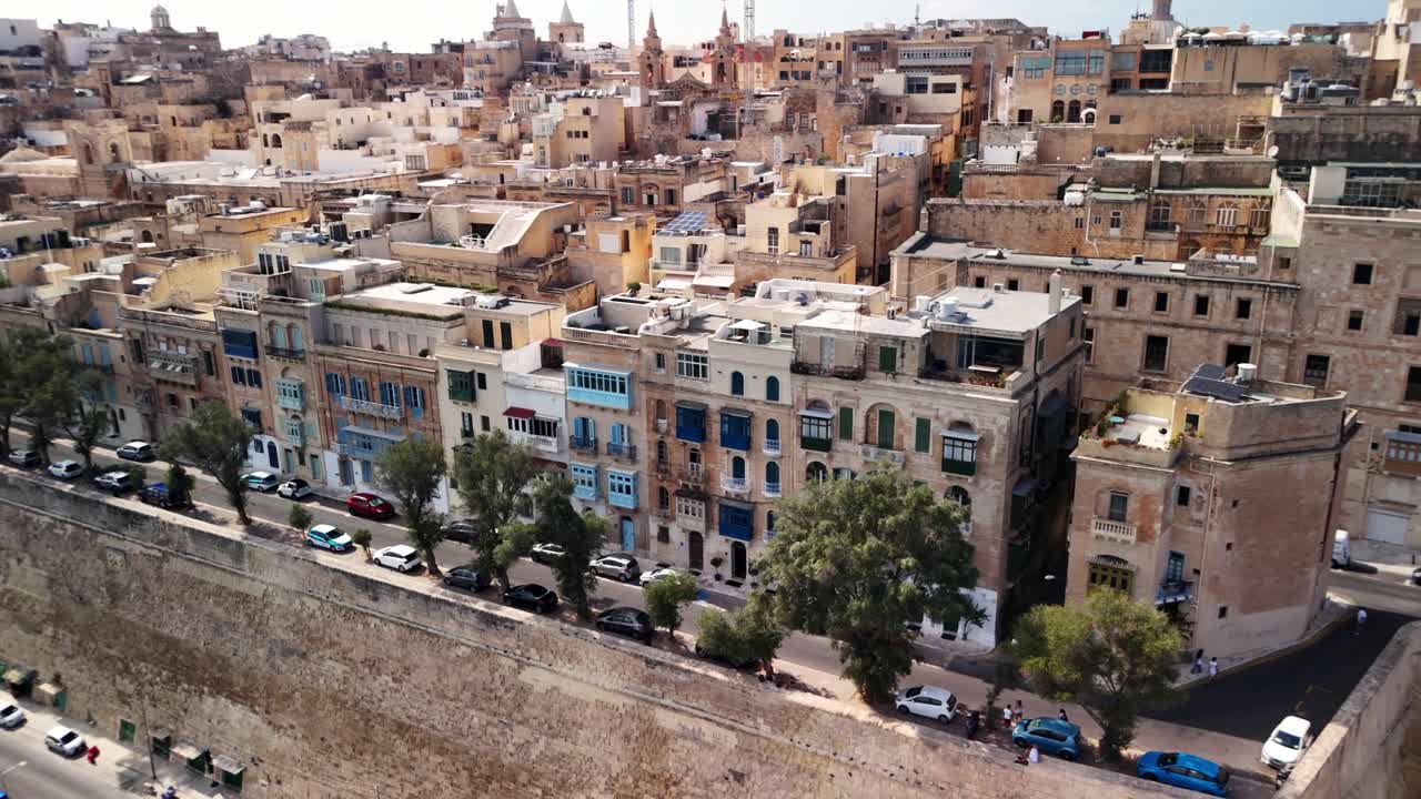 Sunny day over historic city buildings with colorful facades and trees