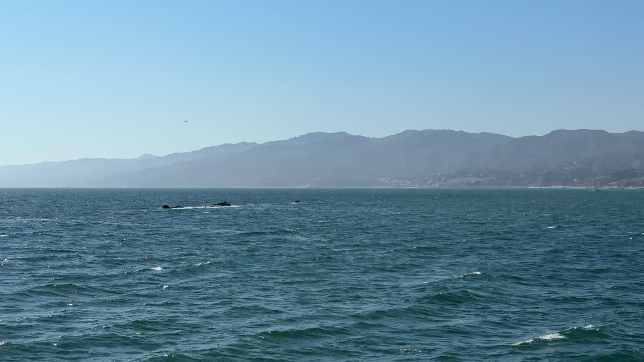 Picturesque view of the ocean and mountain from the Santa Monica Pier in California