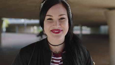 close up portrait of beautiful woman wearing alternative punk fashion laughing cheerrful at camera enjoying life