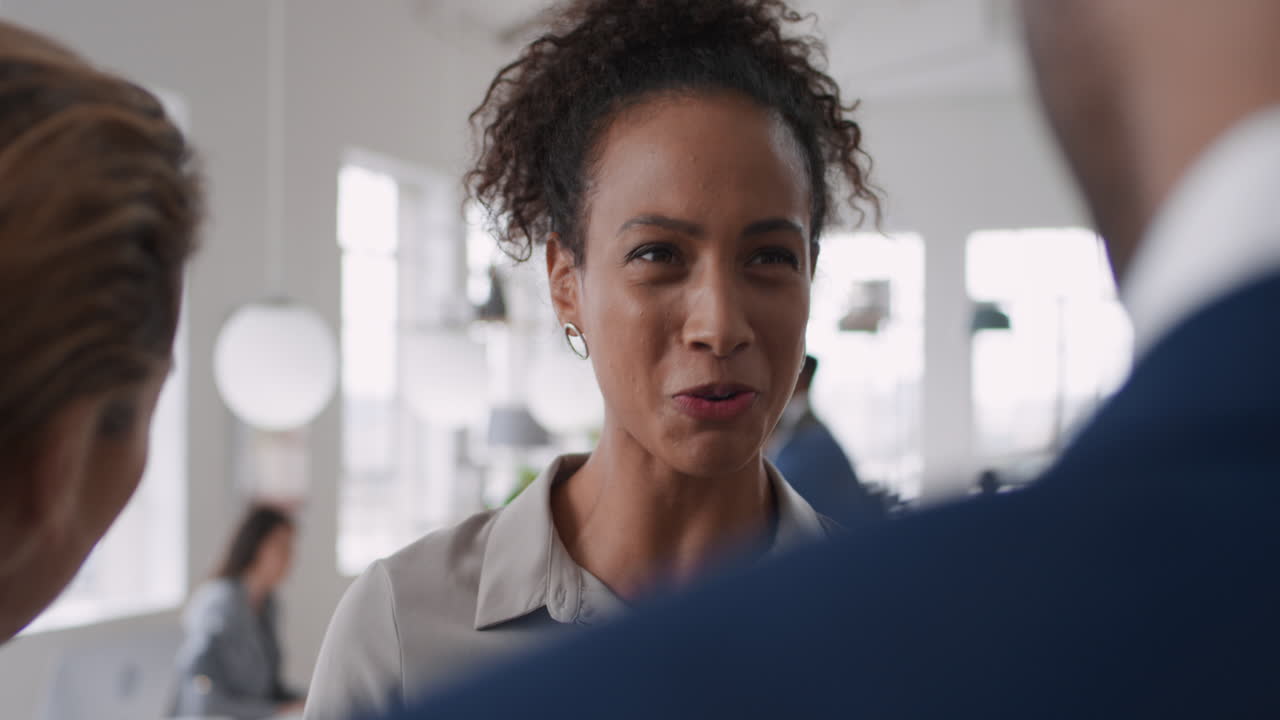 beautiful mixed race business woman meeting clients collaborating planning partnership deal in startup office workspace