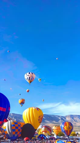 four colorful hot air balloons are flying in the sky above a blue sky