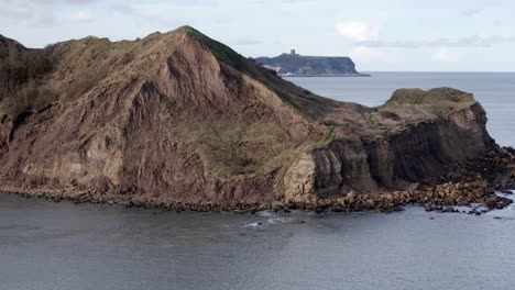 Descending-Aerial-footage-of-North-Yorkshire-coastline-with-Scarborough-town-in-the-distance