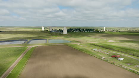 aerial view of rural farmland and town with grain silos