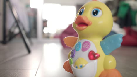 Baby-toy-duck-moving-on-floor.-Musical-toy-with-button-and-lights-moving
