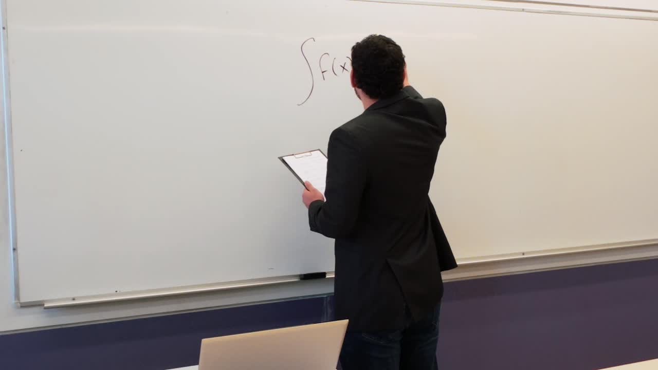 Professor Explaining Antiderivative on Whiteboard