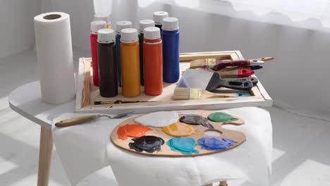 art supplies with paint, palette, and brushes